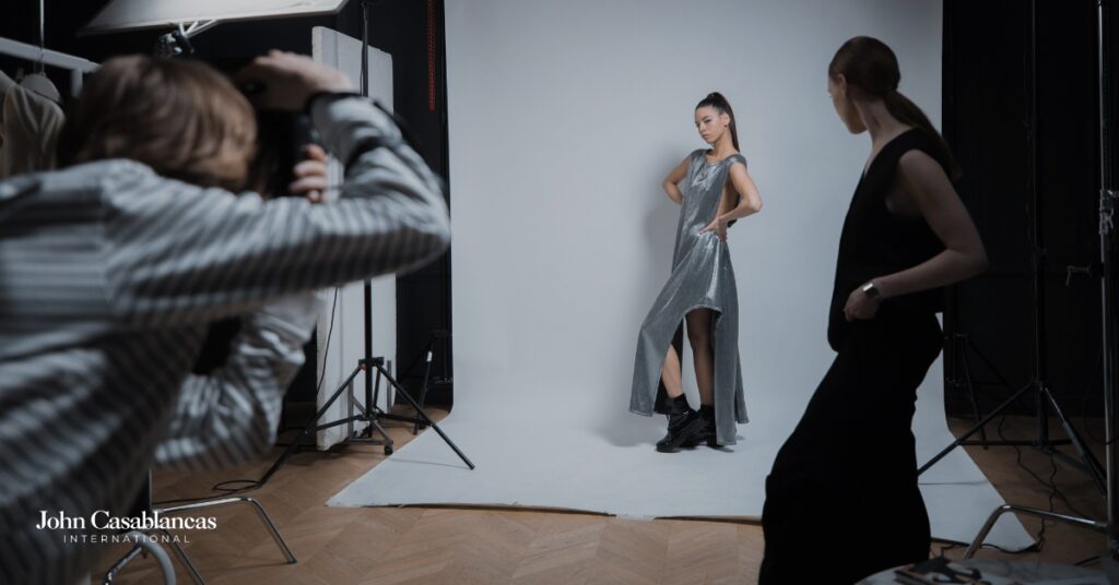 a model posing in front of a backdrop