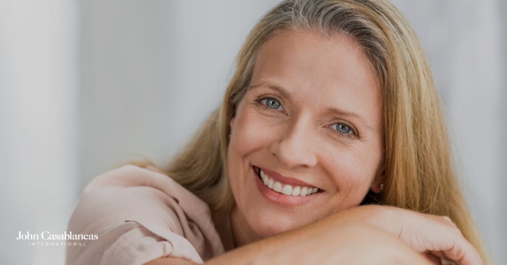 A middle-aged model posing in front of a light background