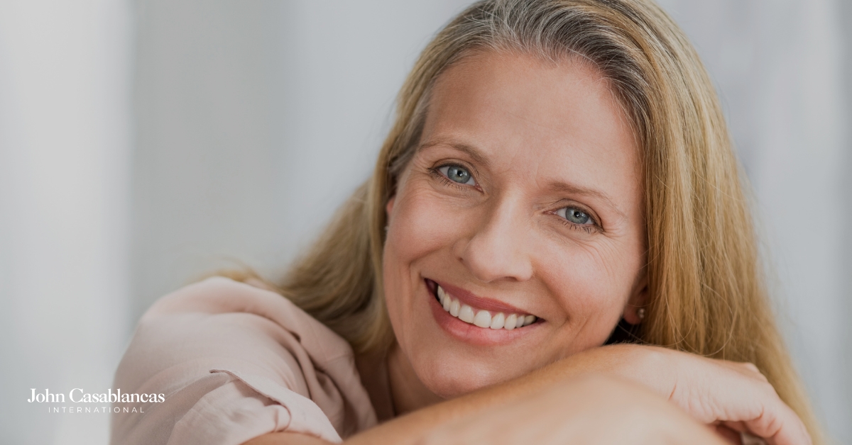 A middle-aged model posing in front of a light background