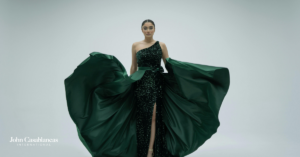 A model on a runway in a green dress