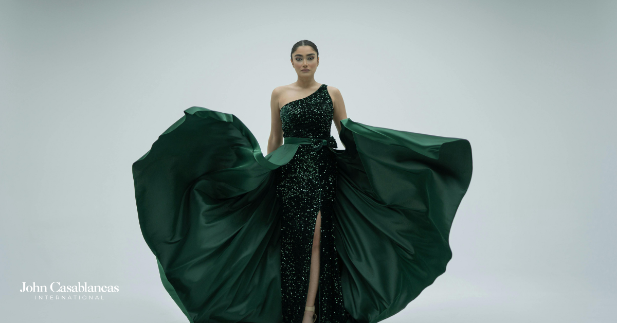 A model on a runway in a green dress